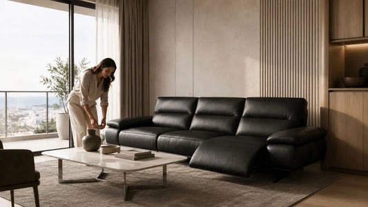 Black leather recliner sofa in a calm Italian modern living room with warm neutral styling