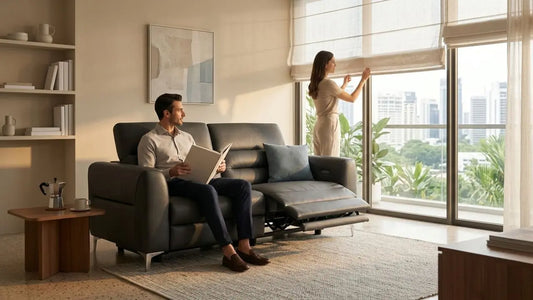 Black leather recliner sofa in a sunlit Singapore living room with sheer curtains and balcony doors, showing how to reduce sofa fading from direct sunlight