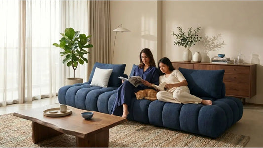 Family relaxing on a blue cat-friendly sofa with a pet cat in a bright Singapore living room