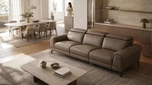 Brown leather sofa anchoring an open-plan Italian-inspired living and dining space with warm neutral styling