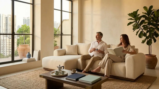 Couple relaxing on a cream sofa in a new BTO living room after planning their furniture setup