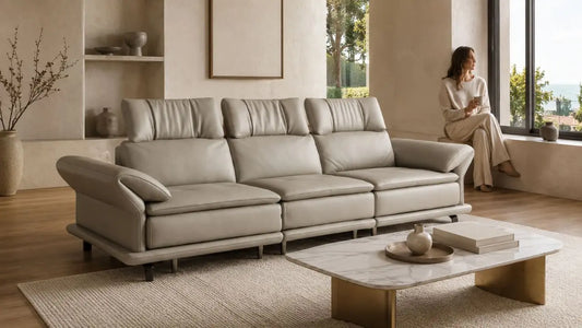 Beige leather sofa in a calm Italian-inspired living room with warm neutral styling for a low-maintenance home