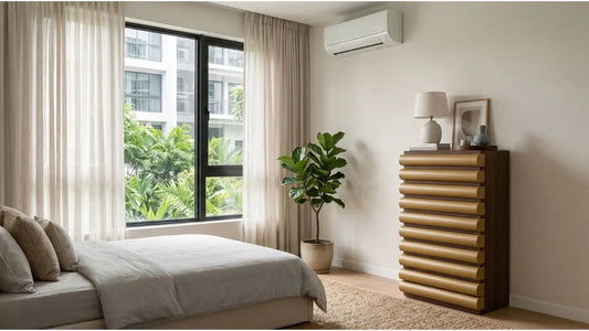 Chest of drawers placed below an aircon unit beside a bedroom window for smart Singapore storage planning