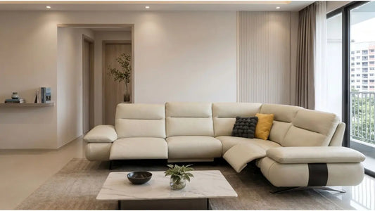 Cream leather L-shaped sofa with recliner chaise, marble coffee table, and neutral finishes in a modern Singapore living room