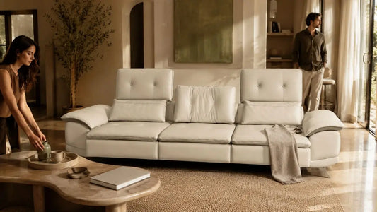 Cream leather sofa in an Italian-inspired living room showing mid-tier furniture value through refined materials and warm styling