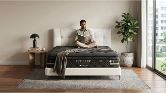Man reading on an Esteller mattress with quilted comfort layers in a calm Singapore bedroom setting