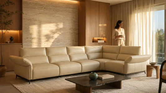 Cream leather sectional sofa in a warm Italian-inspired living room for a guide on fabric vs leather in Singapore.