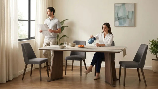 Four-seater dining set with grey upholstered chairs in a warm smaller home dining room