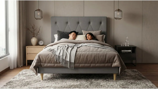 Grey fabric bed frame with wooden legs in a calm HDB-style bedroom with neutral decor