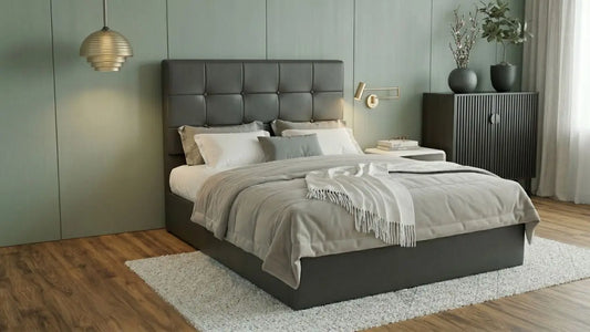 Grey upholstered headboard with wall-mounted reading light, bedside table, and neutral bedding in a modern bedroom