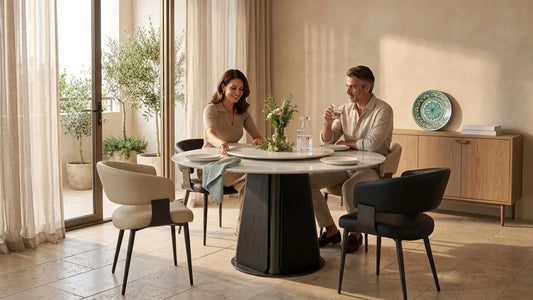 Italian-inspired dining room with round marble table and mismatched dining chairs for first-time homeowners planning a stylish dining area