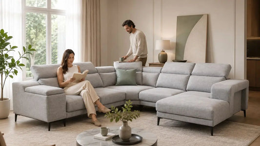 Grey sectional sofa in a Japandi-inspired Singapore living room with warm neutrals and a relaxed couple
