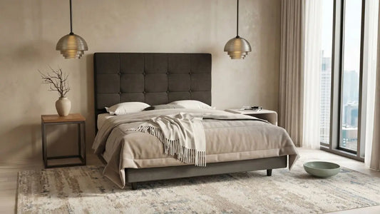 King bed with dark upholstered headboard in a neutral Singapore bedroom with bedside table, pendant lights, and city-view windows.