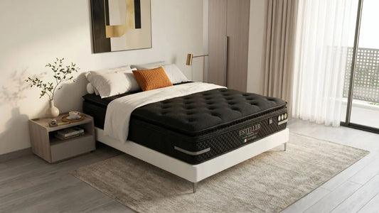 Esteller black mattress styled in a modern Singapore master bedroom with bedside table, rug, balcony light, and neutral furnishings.