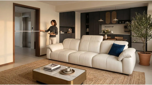 Woman measuring doorway from lift lobby to confirm sofa delivery clearance in a Singapore condo living room