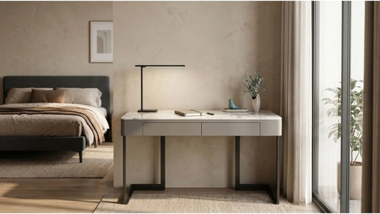 Minimal study nook in a bedroom with slim marble desk, task lamp, and natural window light