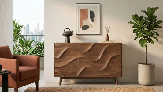 Minimalist wood sideboard styled with wall art, sculptural vase, diffuser, books, and indoor plant