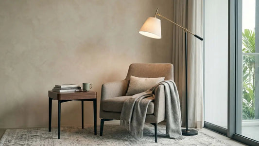 Reading corner with beige armchair, adjustable floor lamp, side table, books, and warm neutral styling in a Singapore home.