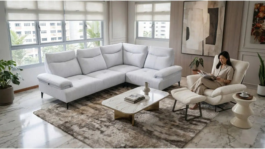 Modern Singapore living room blending a grey L-shaped sofa with a cream lounge chair and warm neutral decor