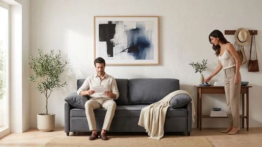 Elegant small entryway furniture layout with grey sofa, wall hooks, console table and indoor plants