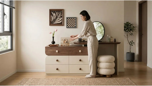 Styled dressing table with makeup organiser, round mirror, drawers, and soft bedroom seating