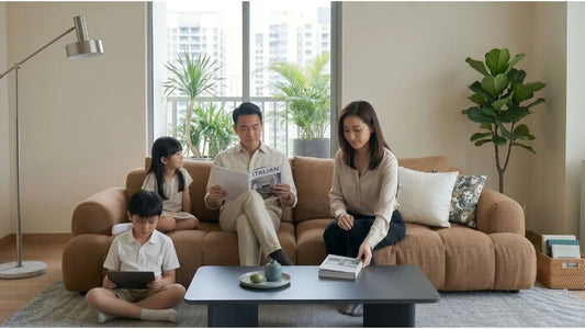 Family relaxing on a tan boucle sofa in a bright Singapore condo living room with indoor plants