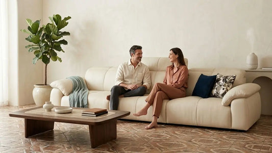 Couple relaxing on a cream sofa in a warm Italian-inspired living room with timeless neutral interior styling