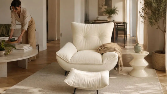 Cream upholstered lounge chair and ottoman in an Italian-inspired living room, styled for a whole-home furnishing project